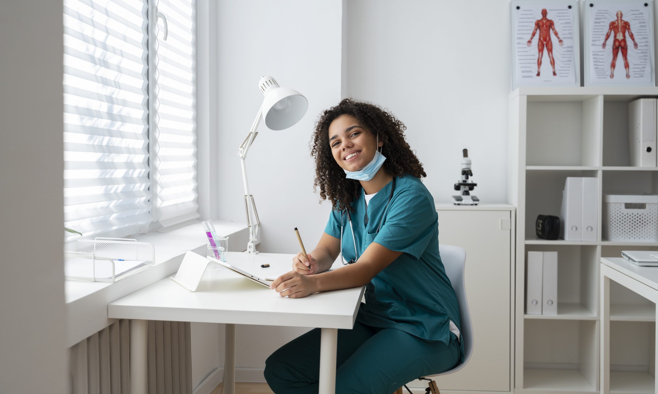 prof-insurance-fp Smiling woman wearing scrubs in white office