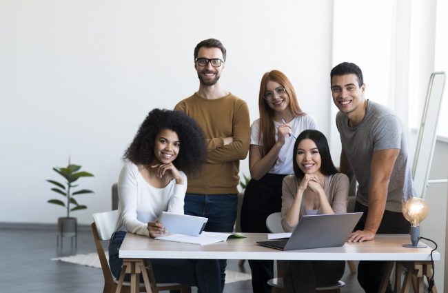 employees-fp Diverse group of employees in office illustrates blog "What Is Group Life Insurance?"