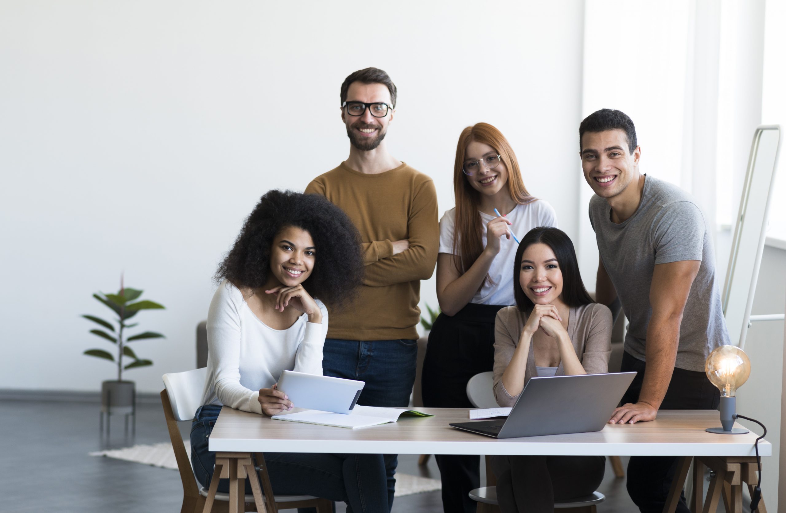 employees-fp Diverse group of employees in office illustrates blog "What Is Group Life Insurance?"