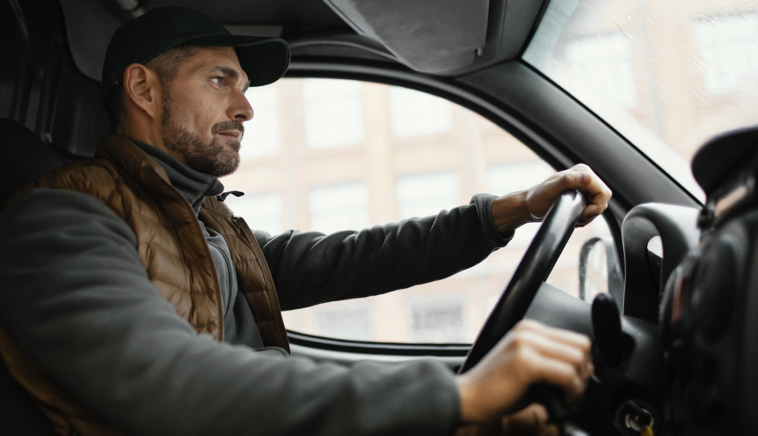 trucker-fp2 Trucker driving seen from a low angle illustrates blog "Does Commercial Auto Insurance Cover Cargo?"