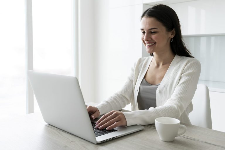 Woman in business attire working on laptop illustrates blog "Commercial Property Insurance: What You Need To Know"