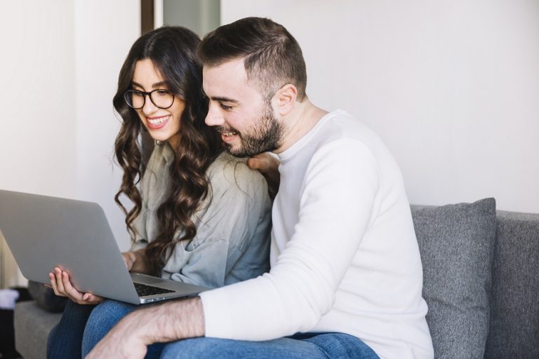 Couple looking at laptop illustrates blog "What Is Mortgage Protection Insurance?"