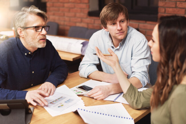 group-creative-people-analyzing-result-work Team reviewing small business liability risks