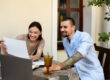 Couple reviewing health insurance plans and employee benefits to avoid costly open enrollment mistakes.