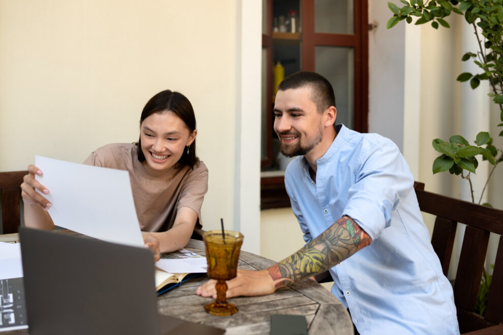Couple reviewing health insurance plans and employee benefits to avoid costly open enrollment mistakes.
