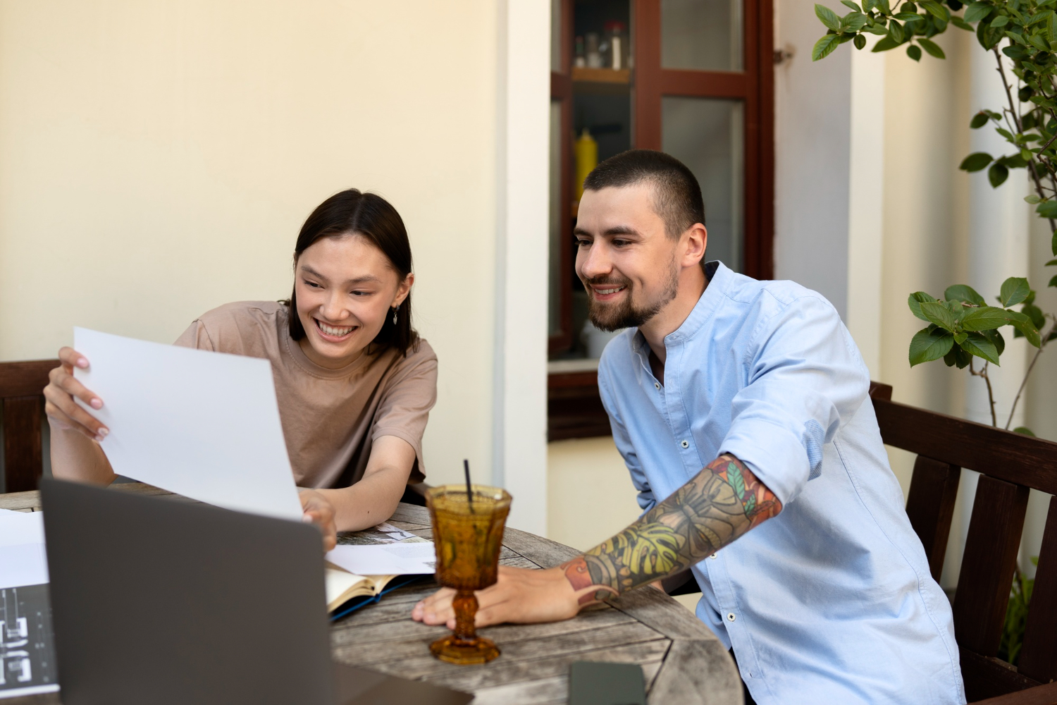 2149563360 Couple reviewing health insurance plans and employee benefits to avoid costly open enrollment mistakes.